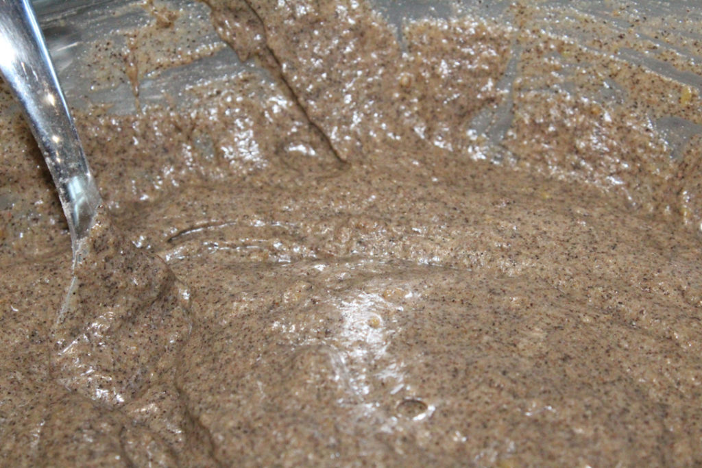 Gluten and dairy free pumpkin spice pancake batter in a bowl with a fork in it.